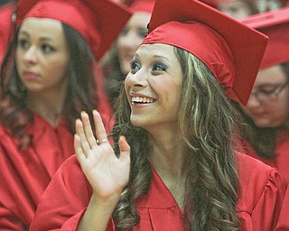 Maria DeAngelis waves to her family in the crowd during the Struthers High School commencement on Sunday
afternoon at the high school.