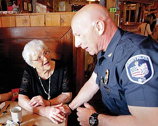 Liberty Police Chief Richard Tisone talks to resident Ann Brown during the annual Senior Watch breakfast Tuesday at West Fork Roadhouse on Belmont Avenue. The program offers seniors wellness checks, lockboxes at their homes for emergency crews, and smoke detectors. The breakfast is an invitation-only event for the program’s participants.