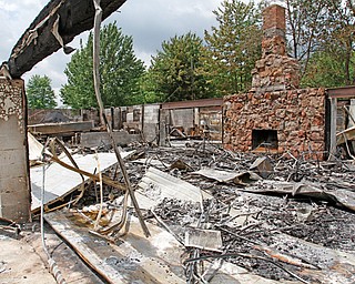 Rubble remains after a Tuesday-morning fire at a clubhouse owned by the Mahoning County Coon Hunters Protective Association. The clubhouse was more than 30 years old and will be rebuilt.
