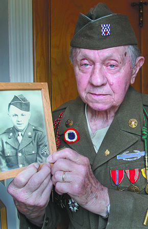 William D Leiws the vindicator WWII vet and Normandy survivor John E. Bistrica of Youngstown holds a photo of himself taken in 1943 when he joined the military.