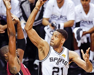 San Antonio Spurs forward Tim Duncan (21) shoots over Miami Heat center Chris Bosh during the first half
in Game 1 of the NBA finals Thursday in San Antonio.