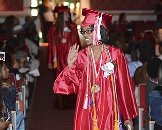 Katie Rickman | The Vindicator.Janay Robinson, Valedictorian, waves to as she walks into the auditorium for graduation at Chaney High School June 6, 2014.