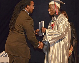 Katie Rickman | The Vindicator.James Gordon recieves his diploma from Ronald Shadd at Chaney High School commencement June 6, 2014.