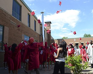 Katie Rickman | The Vindicator.Chaney students throw their hats into the air after commencement June 6, 2014.