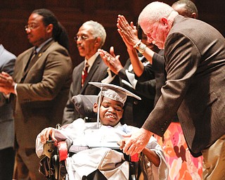 ROBERT K. YOSAY | THE VINDICATOR.. Michael Murphy Youngstown School Board congratulates Kahlil BOwen on his diploma... East High School graduation Friday morning at Stambaugh Auditorium