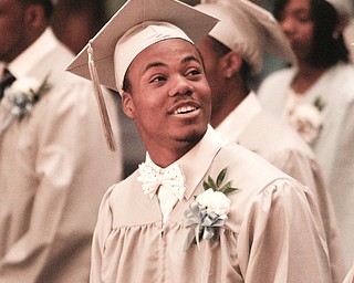 ROBERT K. YOSAY | THE VINDICATOR.. Smile for his family asCurtis Bevly looks to the balcony.. East High School graduation Friday morning at Stambaugh Auditorium