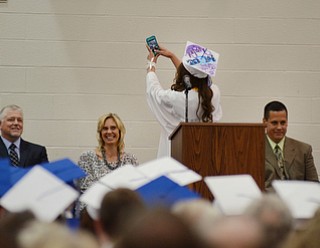 Katie Rickman | The Vindicator .Valedictorian Taylor Tharp takes a "selfie" saying "I want to remember where I came from..." Board of Education members laugh as they watch her turn and take a photo. L-R on stage Mitch Mascioli, Michele Catania, Taylor Tharp, and Principal David Vega.