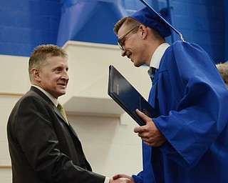 Katie Rickman | The Vindicator .Jackson Milton's Tyler Staton walks across the platform and receives his diploma from Board of Education Vice President Victor Wolfe June 6, 2014.