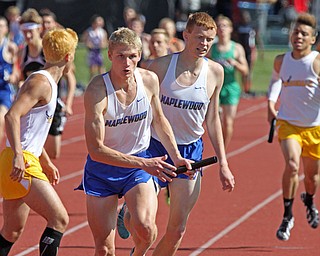 Solomon Yoder of Cortland Maplewood takes the handoff from teammate Jake Hall in the 4X800 relay as the McDomald team(yellow) follows in the Division 3 at the State Meet at the Jesse Owens Memorial Stadium in Columbus, Ohio, Friday, June 6, 2014. (Photo/Mark Hall)