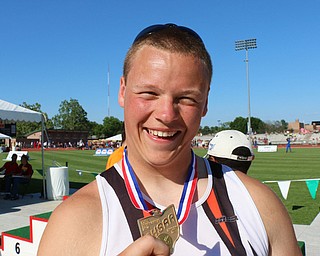 Bucyrus Palo of Newton Falls is all smiles as he holds up the first place medal for winning the states Division 3 Boys discus at the Jesse Owens Memorial Stadium in Columbus, Ohio, Friday, June 6, 2014. (Photo/Mark Hall)