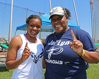 Jai' Lynn Mosley of McDonald poses with her older sister, Joh' Vonnie, after winning the discus event in the Division 3 State Meet at the Jesse Owens Memorial Stadium in Columbus, Ohio, Friday, June 6, 2014. Joh' Vonnie also won this event 4 years ago. (Photo/Mark Hall)