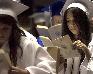 Kelli Cardinal/The Vindicator.Graduate Alexa Ciccone flips through a program Sunday before walking into the fieldhouse for commencement at Poland Seminary High School.