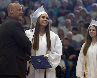 Kelli Cardinal/The Vindicator.Graduate Alexis Benedis receives her diploma Sunday from a Poland Board of Education member during the commencement ceremony at Poland Seminary High School.