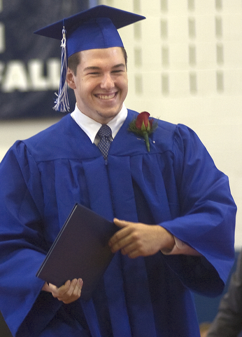 Kelli Cardinal/The Vindicator.Graduate Griffin Marr walks back to his seat Sunday after receiving his diploma during the commencement ceremony at Poland Seminary High School.