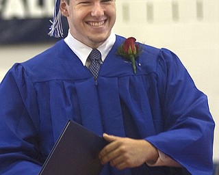 Kelli Cardinal/The Vindicator.Graduate Griffin Marr walks back to his seat Sunday after receiving his diploma during the commencement ceremony at Poland Seminary High School.