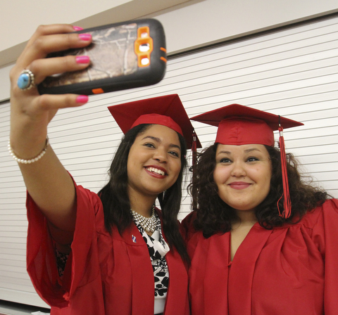 William D Lewis The Vindicator Canfield 2014 grads Queen-Amina Adaego Chijide, left, and Haylee Barker take a selfie before Sunday commencement at CHS.