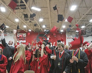 William D Lewis The Vindicator Canfield 2014 grads toss their caps into the air during Sunday commencement at CHS.