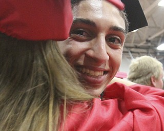 William D Lewis The Vindicator Canfield 2014 grad Kareem Soliman hugs a fellow grad after Sunday commencement at CHS.