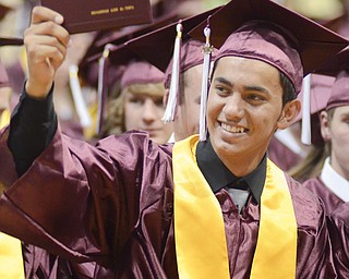 Mohammad Al-Tawil proudly shows his diploma during commencement Sunday in the Boardman High School gymnasium.