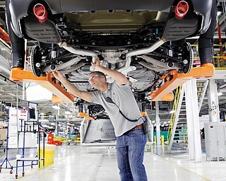 Jeff Caldwell, 29, a chassis assembly-line supervisor, checks a vehicle at the Chrysler Jefferson North Assembly plant in Detroit. The U.S. economy finally regained the jobs lost during the Great Recession, but the comeback is far from complete.