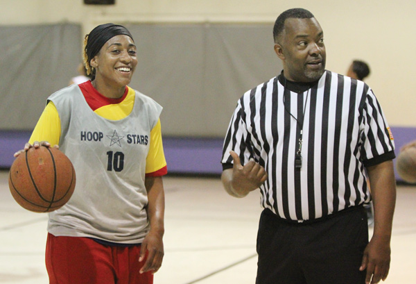 Essence Bell of Akron confers with Northeast Ohio Adult Women’s Basketball League director Delmas Stubs during one of Sunday’s games at the McGuffey Center in Youngstown.