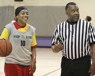 Essence Bell of Akron confers with Northeast Ohio Adult Women’s Basketball League director Delmas Stubs during one of Sunday’s games at the McGuffey Center in Youngstown.