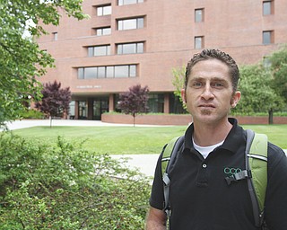 Campus minister Garret White walks on the YSU campus, where the Coalition for Christian Outreach and
Protestant Campus Ministry are partnering.