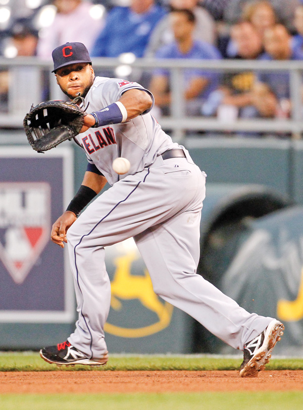 Cleveland first baseman Carlos Santana fields a ground ball hit by Kansas Cit’s Mike Moustakas in the fourth inning Tuesday night. The Royals beat the Indians, 6-2, in the first game of a two-game series in Kansas City.