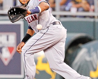 Cleveland first baseman Carlos Santana fields a ground ball hit by Kansas Cit’s Mike Moustakas in the fourth inning Tuesday night. The Royals beat the Indians, 6-2, in the first game of a two-game series in Kansas City.