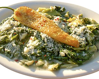 Fried Italian Greens appetizer topped with pecorino Romano cheese and a Hungarian hot pepper.