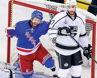 Kings defenseman Alec Martinez looks away as Rangers right wing Martin St. Louis celebrates scoring a goal in the second period of Game 4 of the Stanley Cup Final on Wednesday in New York. The Rangers held on to win 2-1 and avoid a sweep. Game 5 is set for Friday in Los Angeles.