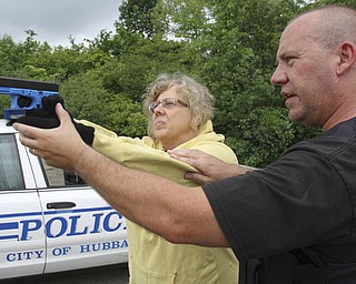 William D Lewis the vindicator Hubbard PD sgt Chris Moffitt gives advice and training to Vindy reporter Jeane Starmack during a training exercise 6-12 at a vacant building in Hubbard.