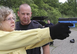 William D Lewis the vindicator Hubbard PD sgt Chris Moffitt gives advice and training to Vindy reporter Jeane Starmack during a training exercise 6-12 at a vacant building in Hubbard.