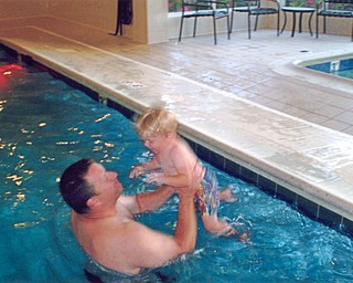 Michael Billy, is coaxing his son, Gabriel, who just turned 2, to jump into the pool to "Daddy will catch you. Don't be afraid." After a few minutes he jumped. Taken at the Hilton Garden Inn in Blue Ash, Ohio, by Grandma Jean Billy.