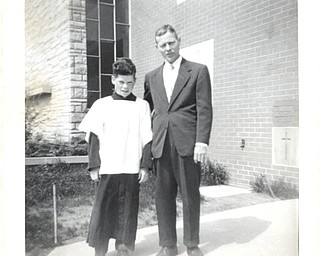 Altar boy, Tommy Dailey, with his father, Joseph E. Dailey, in 1956, are preparing to attend a Mass to honor fathers on Father's Day at St. Christine Church in Youngstown. Tommy's father is his hero.