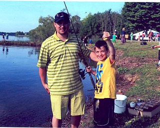 Christopher Calfee with his son, Brandon, catching Brandon's first fish May 31 at Evans Lake in Canfield. Sent by Nana Wittenauer of Youngstown.