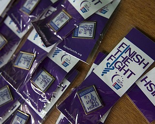 Kelli Cardinal/The Vindicator.Caregiver pins are displayed Friday on the registration table at the 2014 Austintown Relay For Life event in Austintown Township Park.