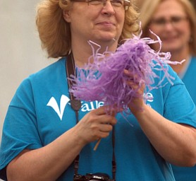 Kelli Cardinal/The Vindicator.Deb Bishop, of Austintown, shakes a pompom Friday for those walking the survivor lap during the 2014 Austintown Relay For Life event in Austintown Township Park.