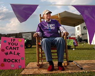 Kelli Cardinal/The Vindicator.Mike Griffin, of Austintown, watches the walkers Friday during the 2014 Austintown Relay For Life event in Austintown Township Park. Griffin has been battling advanced colon cancer for five years.