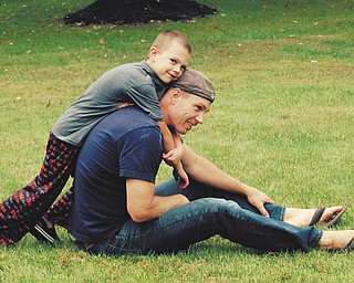Ryan Ward: Andy Ward, 6, and his dad Ryan Ward, enjoyed a rare quiet moment together in their front yard in Poland. Sent by Jennifer Ward.