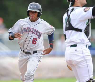 JAMESTOWN, NEW YORK - JUNE 13, 2014: Base runner Joel Mejia #6 of the Scrappers steps on home plate to score the first scrappers run of the game int he top of the 1st inning during a game at Russell Diethrick Park. (Photo by David Dermer/Youngstown Vindicator) Jamestown catcher Taylor Gushue #13 pictured.