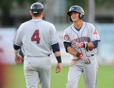 JAMESTOWN, NEW YORK - JUNE 13, 2014: Base runner Yonathan Mendoza #10 of the Scrappers is congratulated by first base coach Shane Rowland after a RBI single in the top of the first inning to make the score 2-0 scrappers during a game at Russell Diethrick Park. (Photo by David Dermer/Youngstown Vindicator)