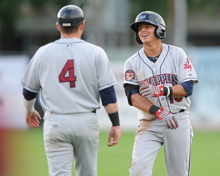 JAMESTOWN, NEW YORK - JUNE 13, 2014: Base runner Yonathan Mendoza #10 of the Scrappers is congratulated by first base coach Shane Rowland after a RBI single in the top of the first inning to make the score 2-0 scrappers during a game at Russell Diethrick Park. (Photo by David Dermer/Youngstown Vindicator)