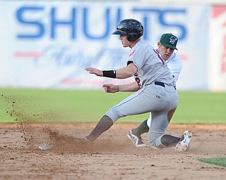 JAMESTOWN, NEW YORK - JUNE 13, 2014: Base runner Austin Fisher #12 of the Scrappers slides into second base to beat the tag of infielder Erik Lunde #6 of Jamestown during the top of the 2nd inning during a game at Russell Diethrick Park. (Photo by David Dermer/Youngstown Vindicator)