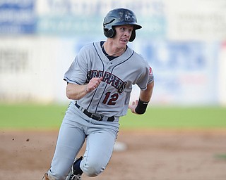 JAMESTOWN, NEW YORK - JUNE 13, 2014: Base runner Austin Fisher #12 of the Scrappers sprints to third base to head home and score a run in the top of the 2nd inning during a game at Russell Diethrick Park. (Photo by David Dermer/Youngstown Vindicator)