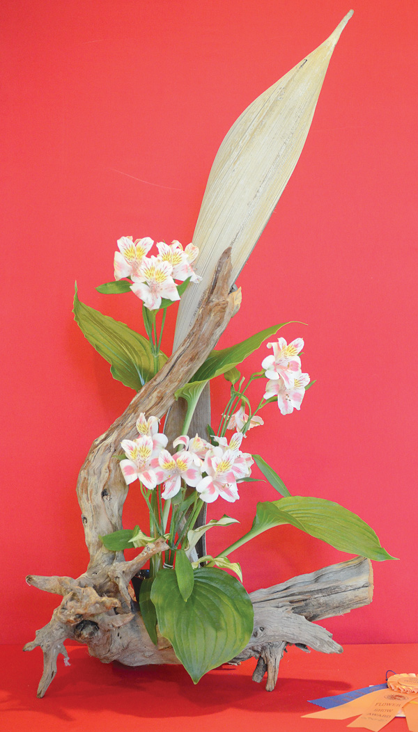 Best of show in the design category of the summer flower show sponsored by the Garden Forum of Greater Youngstown is this creation by Millie Campean of Gleaners Flower Club. It features alstromeria flowers, hosta, driftwood and palm spathe. The event was Sunday.