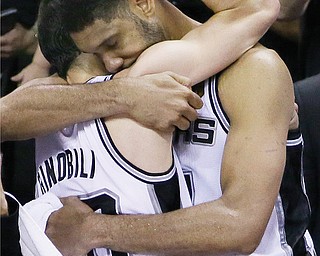 San Antonio Spurs guard Manu Ginobili, left, and forward Tim Duncan embrace in the final moments of Game
5 of the NBA Finals against the Miami Heat on Sunday at the AT&T Center in San Antonio. Ginobili posted 19 points, and Duncan contributed 14 as the Spurs dominated the Heat, winning the game 104-87 and the series
4-1, and earning their fifth title.