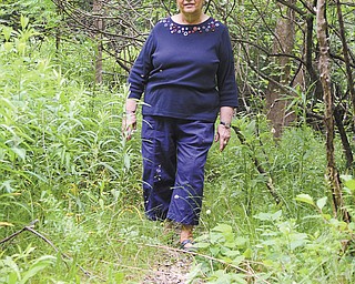 Barbara Tesyk, a 1957 graduate of Struthers High School and the city’s deputy tax clerk, walks along a small portion of what used to be Struthers Municipal Pool in Yellow Creek Park.