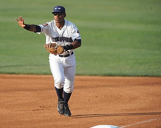 NILES, OHIO - JUNE 17, 2014: Infielder Juan De La Cruz #24 of the Scrappers calls off the pitcher while sprinting to first base to force out the base runner for the 2nd out in the top of the 1st inning during Tuesday nights New York Penn League game at Eastwood Field. (Photo by David Dermer/Youngstown Vindicator)