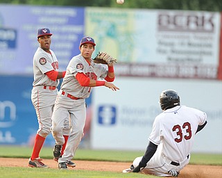NILES, OHIO - JUNE 17, 2014: Infielder Bryan Mejia #1 of the Doubledays throws the ball to first base to turn a double play after stepping on second to force out base runner Jorge martinez #33 of the Scrappers in the bottom of the 5th inning during Tuesday nights New York Penn League game at Eastwood Field. (Photo by David Dermer/Youngstown Vindicator) Infielder Osvaldo Abreu #7 pictured.